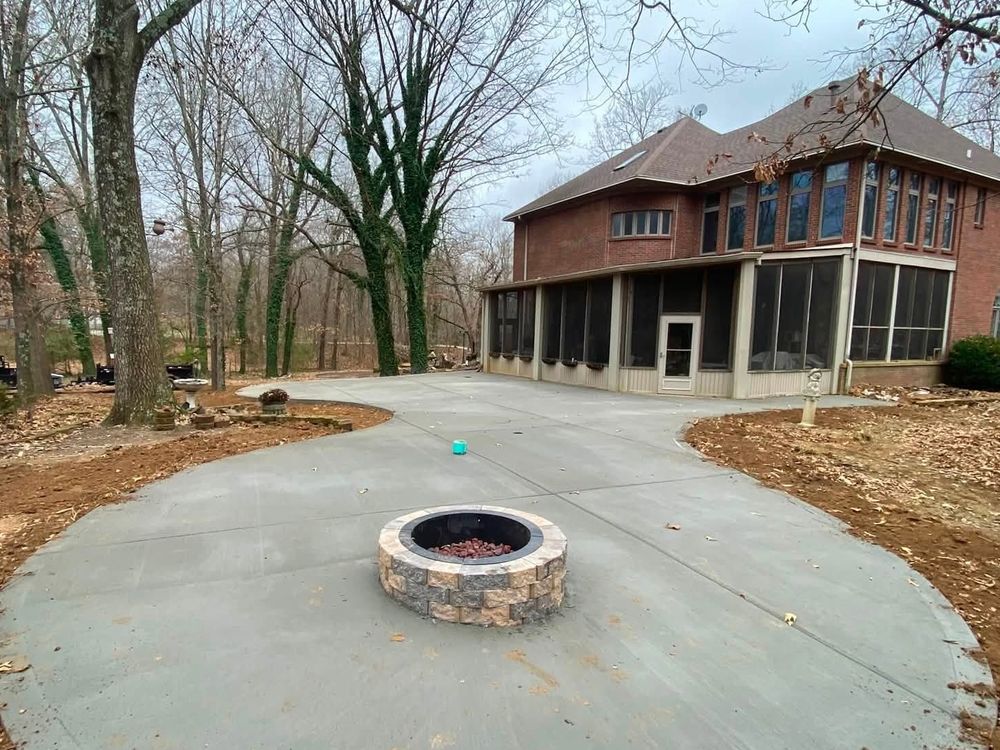 Backyard concrete patio with built-in fire pit and screened porch, complete outdoor living space